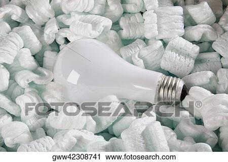 Stock Image - Close-up of a light bulb on packing peanuts. Fotosearch