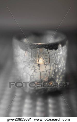 Stock Image - Close-up of a lit candle in a glass. Fotosearch