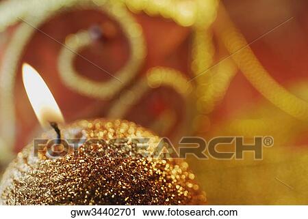 Stock Image - Close-up of a lit candle. Fotosearch