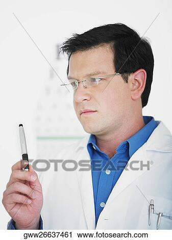 Close-up of a male doctor holding a pen View Large Photo Image Stock Image - Close-up of a male doctor holding a pen. Fotosearch