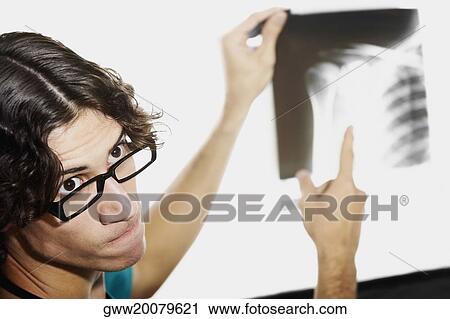 Close-up of a male doctor holding an X-Ray View Large Photo Image Stock Image - Close-up of a male doctor holding an X-Ray. Fotosearch