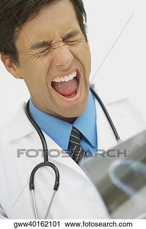 Stock Image - Close-up of a male doctor looking frustrated. Fotosearch