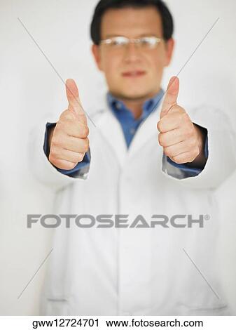 Close-up of a male doctor showing a thumbs up sign View Large Photo Image Stock Image - Close-up of a male doctor showing a thumbs up sign. Fotosearch