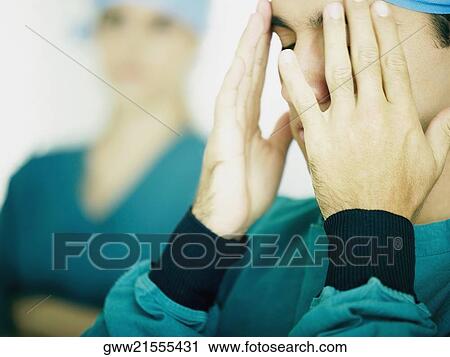 Close-up of a male doctor thinking View Large Photo Image Stock Image - Close-up of a male doctor thinking. Fotosearch