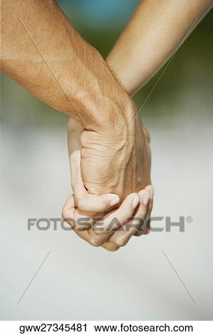 Close-up of a man's hand holding a woman's hand View Large Photo Image Stock Image - Close-up of a man's hand holding a woman's hand. Fotosearch