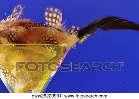 Close-up of a martini glass full of feathers View Large Photo Image Stock Image - Close-up of a martini glass full of feathers. Fotosearch