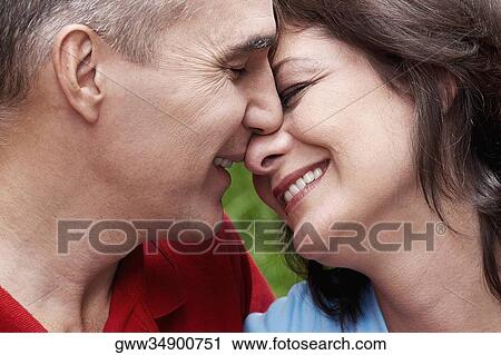 Close-up of a mature couple smiling View Large Photo Image Stock Image - Close-up of a mature couple smiling. Fotosearch