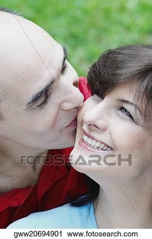 Close-up of a mature man kissing a mature woman smiling View Large Photo Image Stock Image - Close-up of a mature man kissing a mature woman smiling. Fotosearch