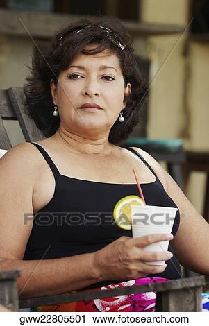 Close-up of a mature woman holding a glass of juice View Large Photo Image Stock Image - Close-up of a mature woman holding a glass of juice. Fotosearch