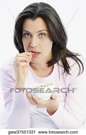 Close-up of a mature woman holding a bowl of cereal View Large Photo Image Stock Image - Close-up of a mature woman holding a bowl of cereal. Fotosearch
