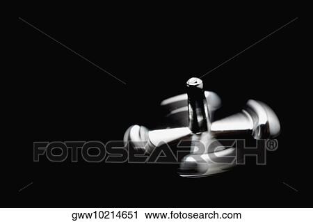 Stock Image - Close-up of a metal knob spinning. Fotosearch