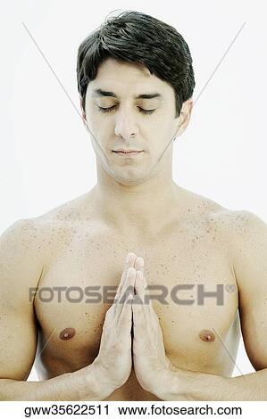 Close-up of a mid adult man in a prayer position View Large Photo Image Stock Image - Close-up of a mid adult man in a prayer position. Fotosearch