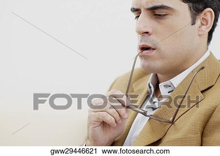 Close-up of a mid adult man thinking View Large Photo Image Stock Image - Close-up of a mid adult man thinking. Fotosearch
