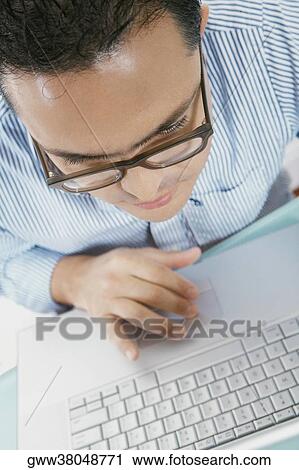 Close-up of a mid adult man working on a laptop View Large Photo Image Stock Image - Close-up of a mid adult man working on a laptop. Fotosearch
