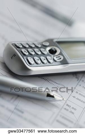 Stock Image - Close-up of a mobile phone and a pen on a sheet of paper. Fotosearch