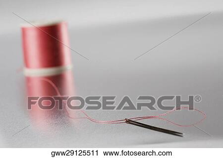 Close-up of a needle with a spool of thread View Large Photo Image Stock Image - Close-up of a needle with a spool of thread. Fotosearch