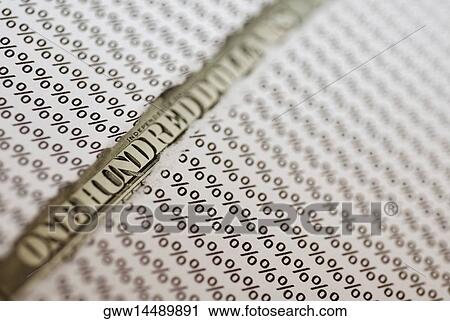 Stock Image - Close-up of a one hundred dollar bill under a torn paper. Fotosearch
