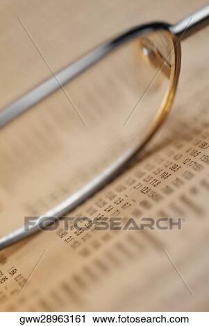 Stock Image - Close-up of a pair of eyeglasses on a document. Fotosearch