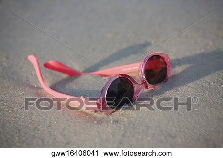 Close-up of a pair of sunglasses on the beach View Large Photo Image Stock Image - Close-up of a pair of sunglasses on the beach. Fotosearch