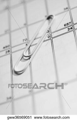 Stock Image - Close-up of a paper clip on a sheet of paper. Fotosearch