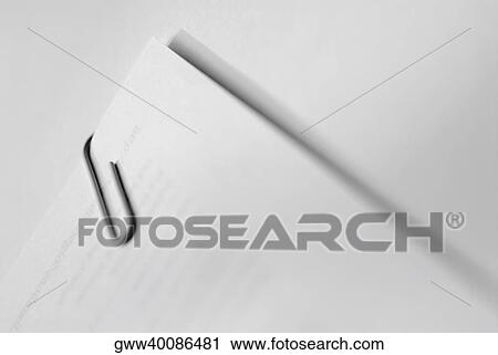 Stock Image - Close-up of a paper clip on papers. Fotosearch