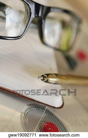 Close-up of a pen and a pair of eyeglasses on a dairy View Large Photo Image Stock Image - Close-up of a pen and a pair of eyeglasses on a dairy. Fotosearch