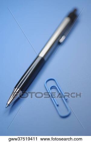 Stock Image - Close-up of a pen and a paper clip. Fotosearch