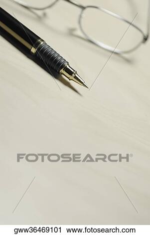Close-up of a pen and eyeglasses on the table View Large Photo Image Stock Image - Close-up of a pen and eyeglasses on the table. Fotosearch