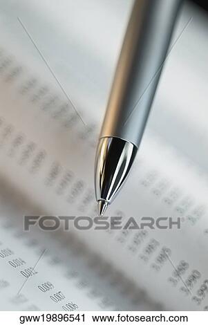 Stock Image - Close-up of a pen on a financial page. Fotosearch