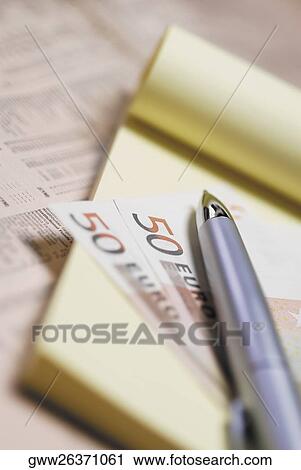 Close-up of a pen on two fifty Euro banknotes with a notepad View Large Photo Image Stock Image - Close-up of a pen on two fifty Euro banknotes with a notepad. Fotosearch