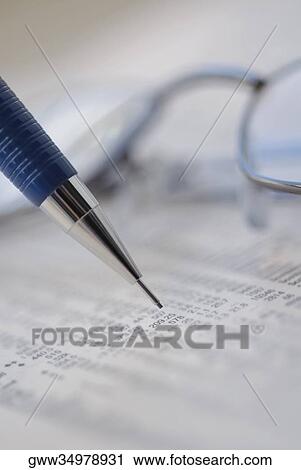 Close-up of a pen with a financial newspaper View Large Photo Image Stock Image - Close-up of a pen with a financial newspaper. Fotosearch