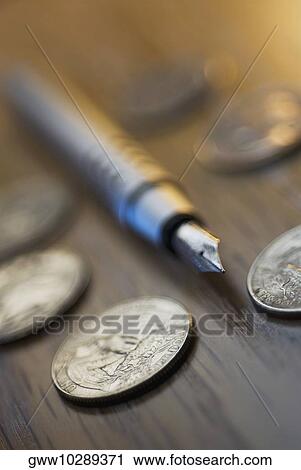 Close-up of a pen with coins View Large Photo Image Stock Image - Close-up of a pen with coins. Fotosearch