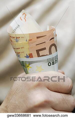 Close-up of a person holding fifty Euro banknotes View Large Photo Image Stock Image - Close-up of a person holding fifty Euro banknotes. Fotosearch