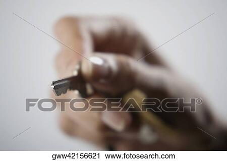 Close-up of a person's hand holding a key View Large Photo Image Stock Image - Close-up of a person's hand holding a key. Fotosearch