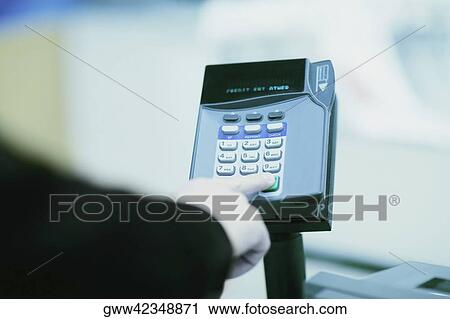 Close-up of a person's hand using a credit card machine View Large Photo Image Stock Image - Close-up of a person's hand using a credit card machine. Fotosearch