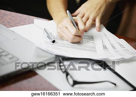 Close-up of a person's hand writing on a document View Large Photo Image Stock Image - Close-up of a person's hand writing on a document. Fotosearch