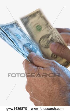 Close-up of a person's hands holding two dollar bills View Large Photo Image Stock Image - Close-up of a person's hands holding two dollar bills. Fotosearch