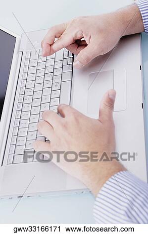 Close-up of a person's hands working on a laptop and crossing his finger View Large Photo Image Stock Image - Close-up of a person's hands working on a laptop and crossing his finger. Fotosearch