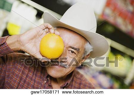 Close-up of a senior man holding an orange View Large Photo Image Stock Image - Close-up of a senior man holding an orange. Fotosearch