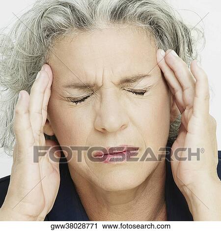 Close-up of a senior woman rubbing her temple View Large Photo Image Stock Image - Close-up of a senior woman rubbing her temple. Fotosearch