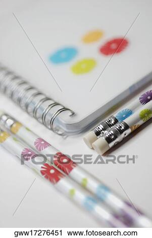 Stock Image - Close-up of a spiral notebook with pencils. Fotosearch