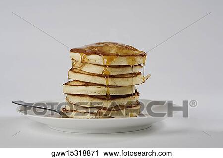 Stock Image - Close-up of a stack of bread with honey in a plate. Fotosearch