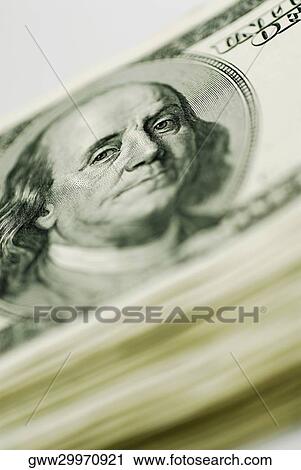 Stock Image - Close-up of a stack of dollar bills. Fotosearch