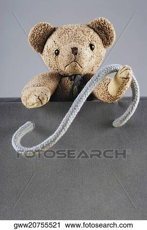 Close-up of a teddy bear in a shopping bag View Large Photo Image Stock Image - Close-up of a teddy bear in a shopping bag. Fotosearch