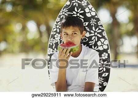 Close-up of a teenage boy eating a slice of watermelon View Large Photo Image Stock Image - Close-up of a teenage boy eating a slice of watermelon. Fotosearch
