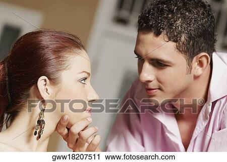 Close-up of a teenage boy touching a young woman's chin View Large Photo Image Stock Image - Close-up of a teenage boy touching a young woman's chin. Fotosearch