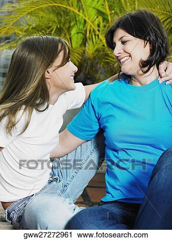 Close-up of a teenage girl and her mother smiling View Large Photo Image Stock Image - Close-up of a teenage girl and her mother smiling. Fotosearch