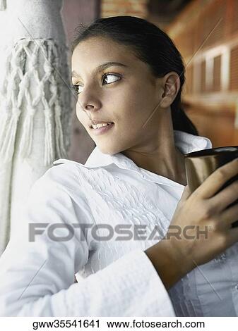 Close-up of a teenage girl holding a cup of coffee View Large Photo Image Stock Image - Close-up of a teenage girl holding a cup of coffee. Fotosearch