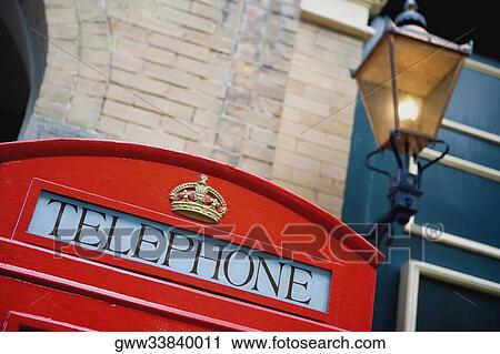 Close-up of a telephone booth outside a building View Large Photo Image Stock Image - Close-up of a telephone booth outside a building. Fotosearch
