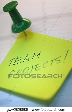 Stock Image - Close-up of a thumbtack on an adhesive note. Fotosearch